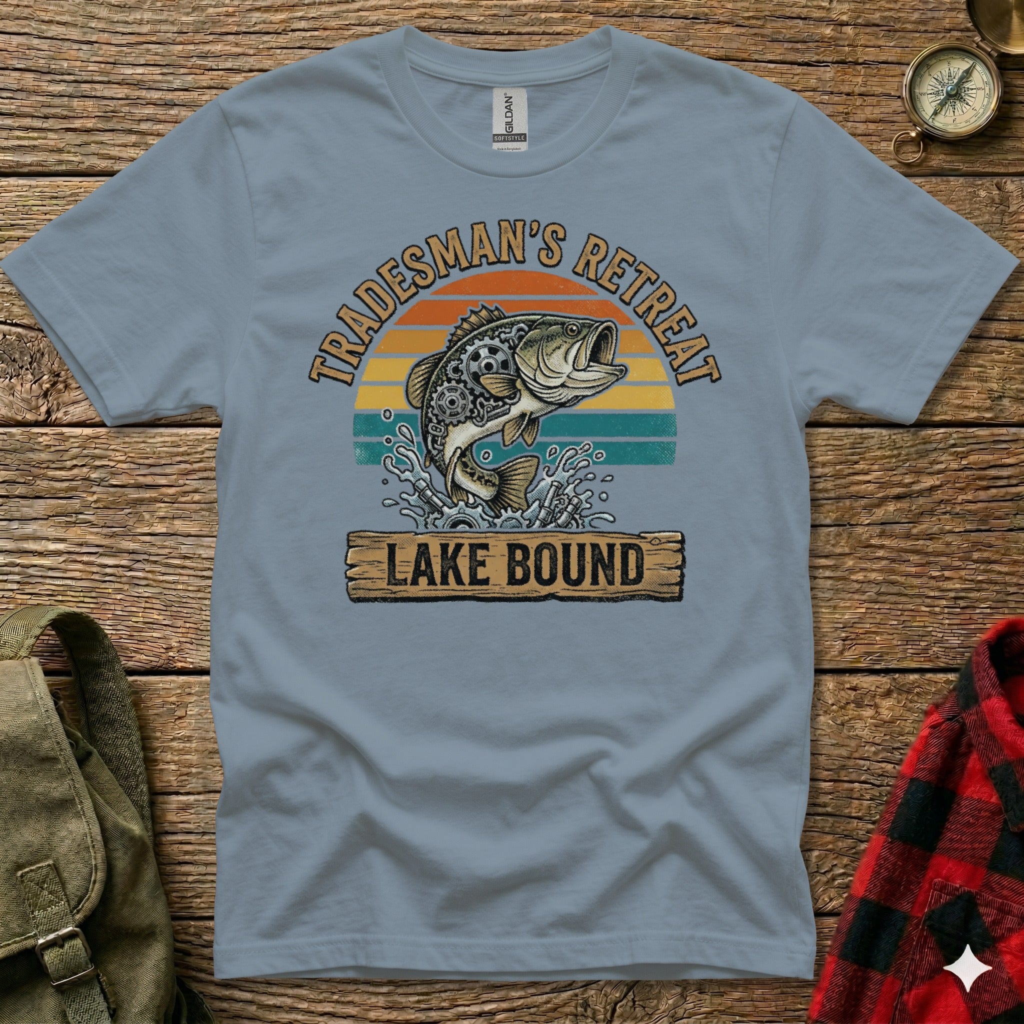 Light blue t-shirt with "Tradesman's Retreat Lake Bound" text and jumping fish graphic.