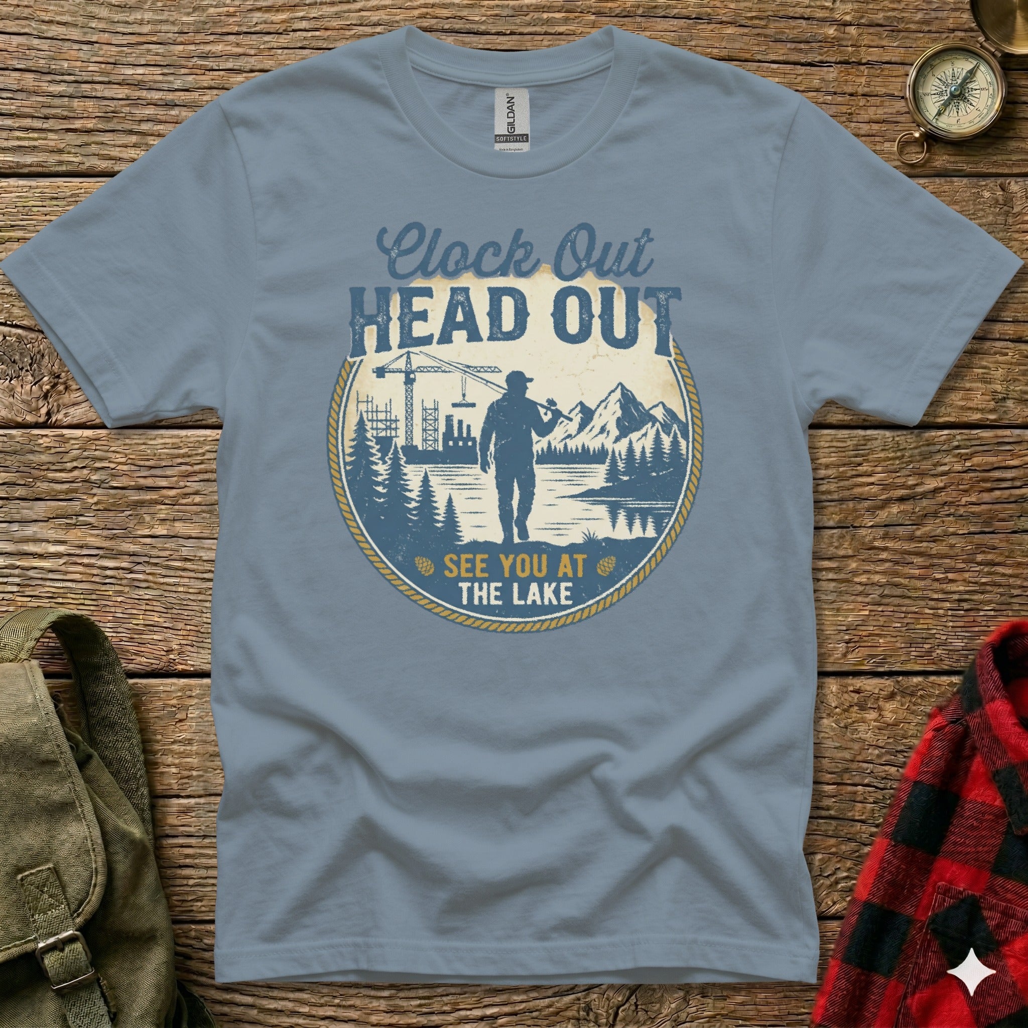 Blue t-shirt with graphic "Clock Out Head Out See You At The Lake".