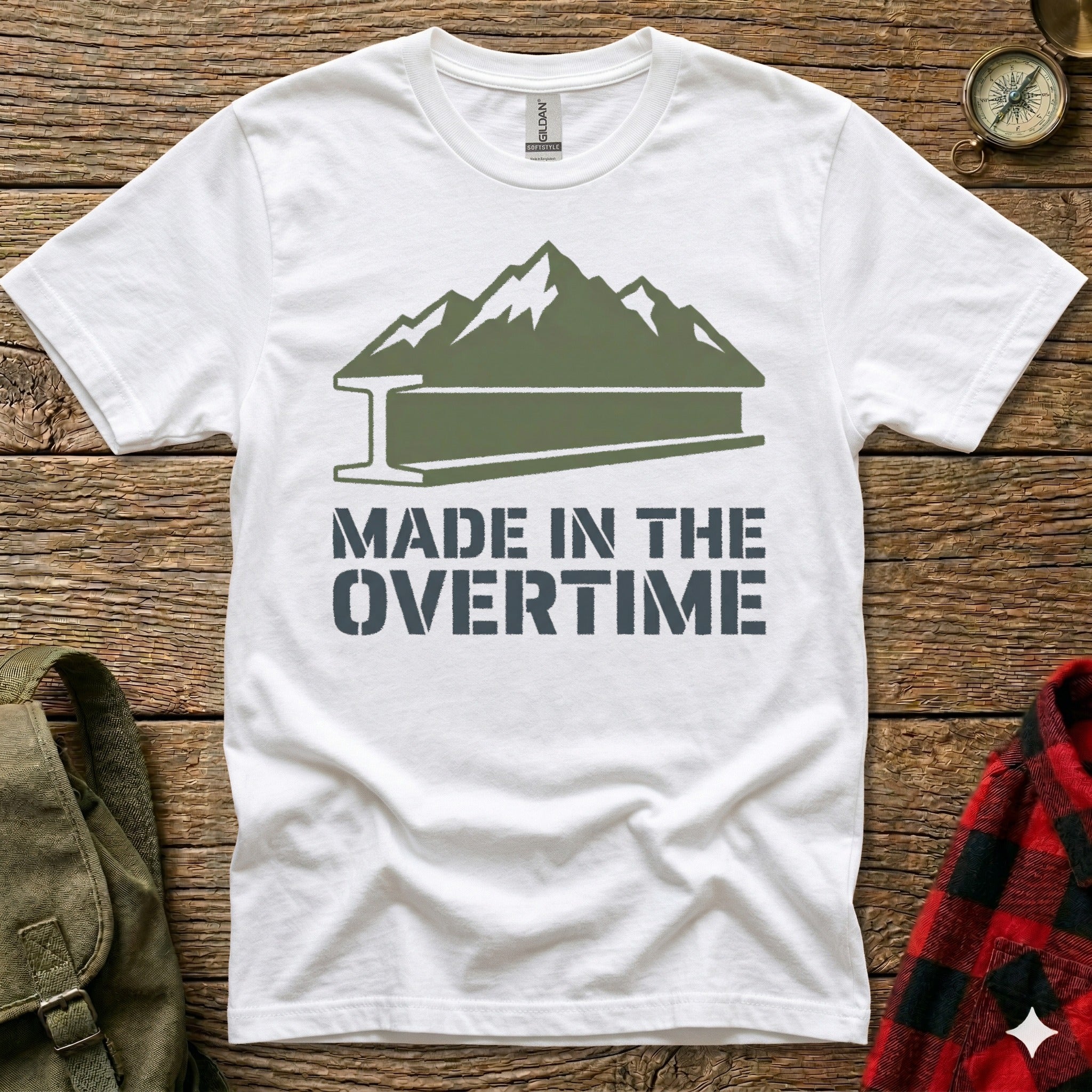 White t-shirt with "Made in the Overtime" text and mountain silhouette.
