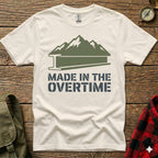 White t-shirt with mountains, I-beam, and "MADE IN THE OVERTIME" text.