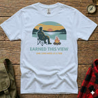White t-shirt with a man camping and campfire graphic.