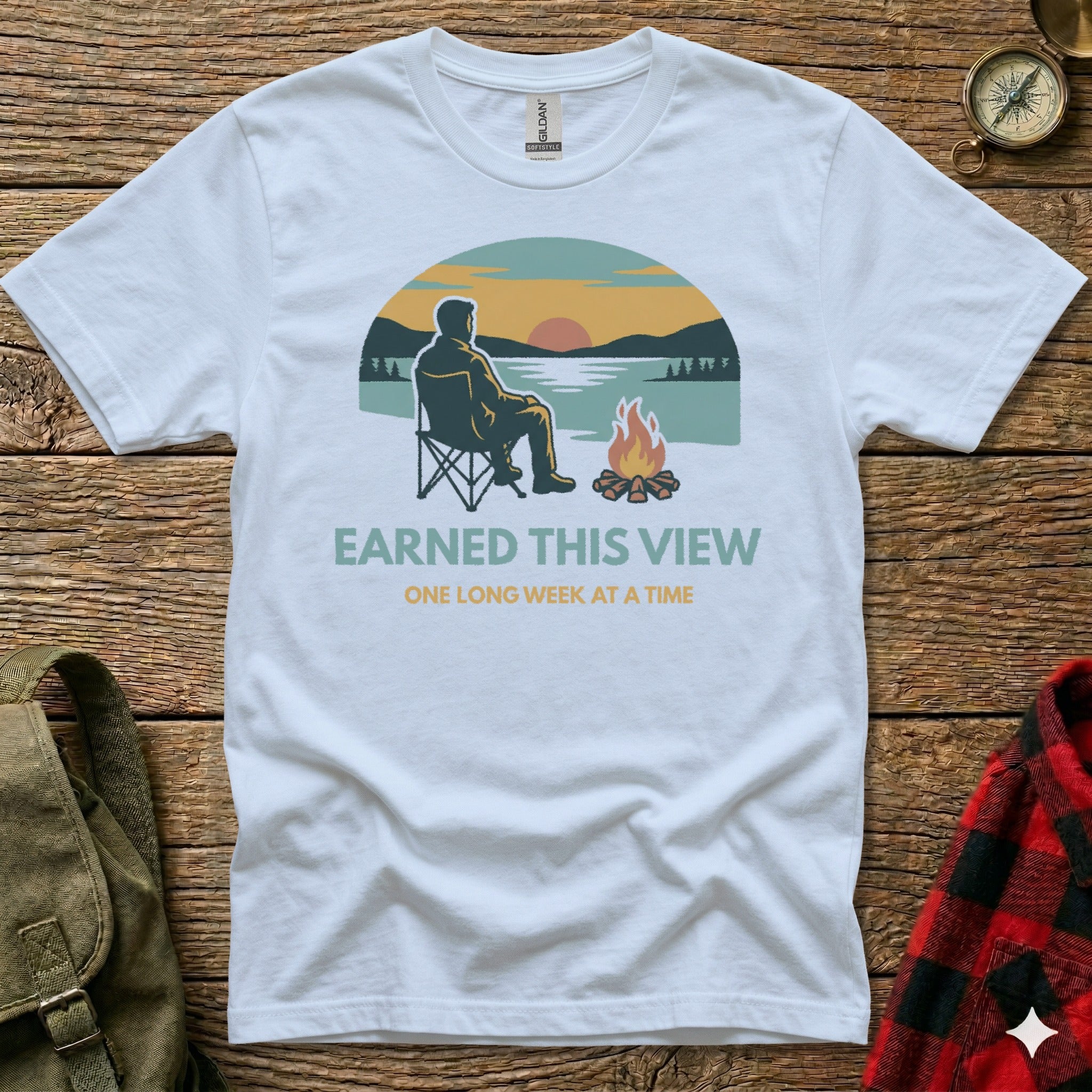 White t-shirt with a man camping and campfire graphic.
