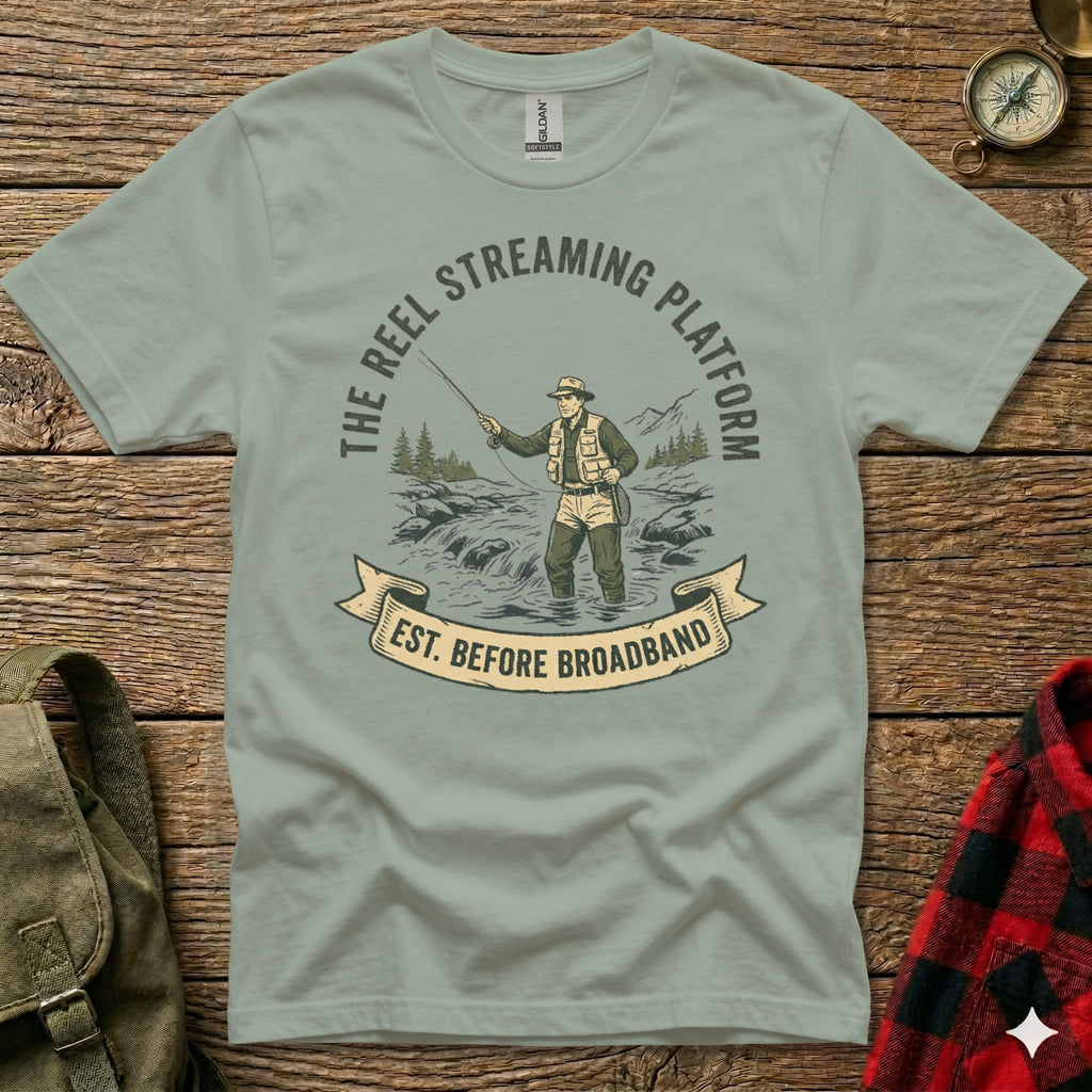 T-shirt graphic: Fisherman in water with "The Reel Streaming Platform Est. Before Broadband" text.