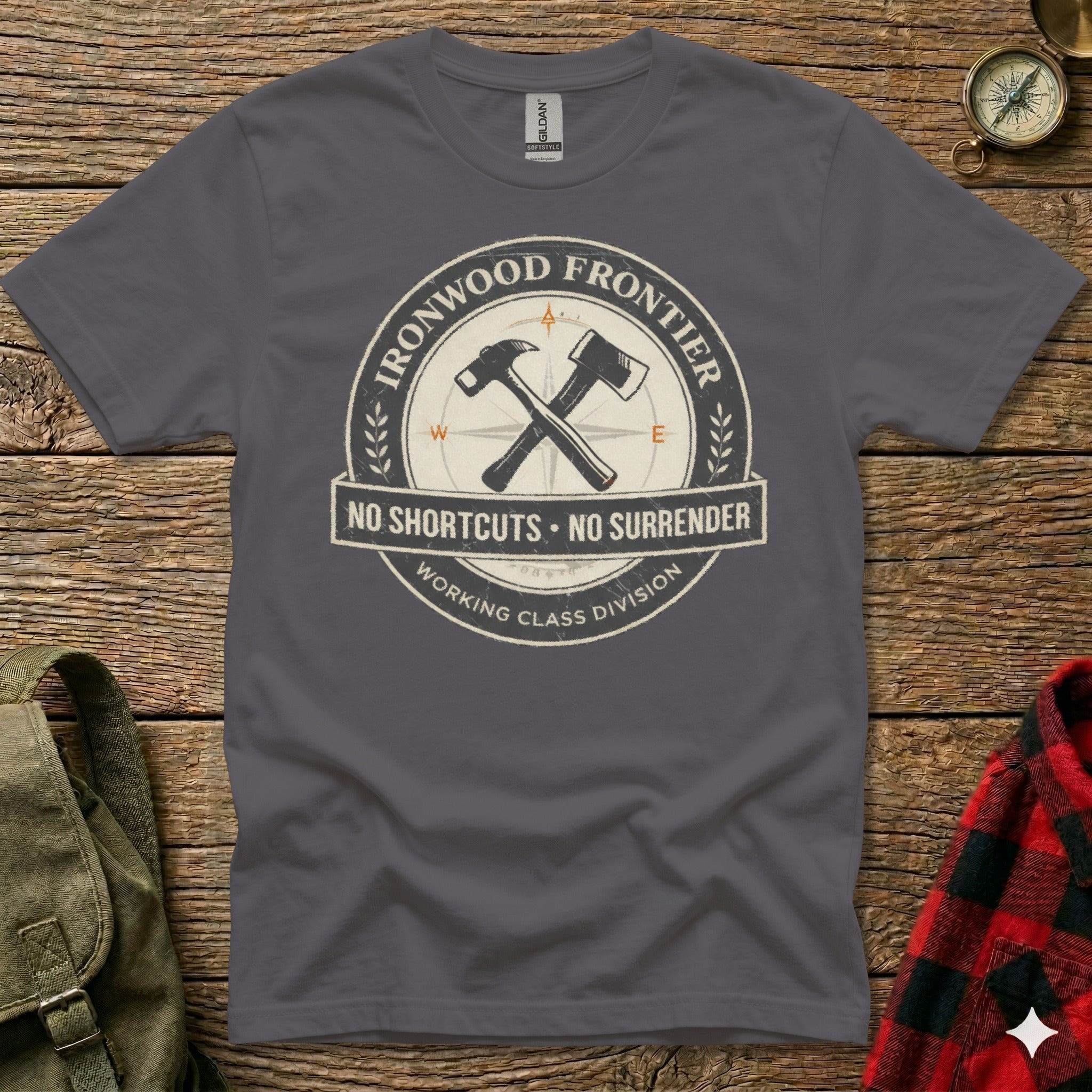 Dark grey t-shirt with Ironwood Frontier logo, hammers, compass, and text.