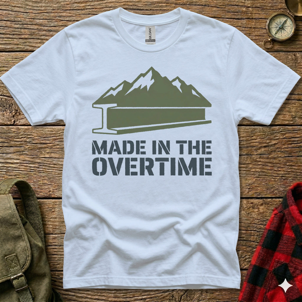 White t-shirt with mountain and steel beam graphic, "MADE IN THE OVERTIME" text.