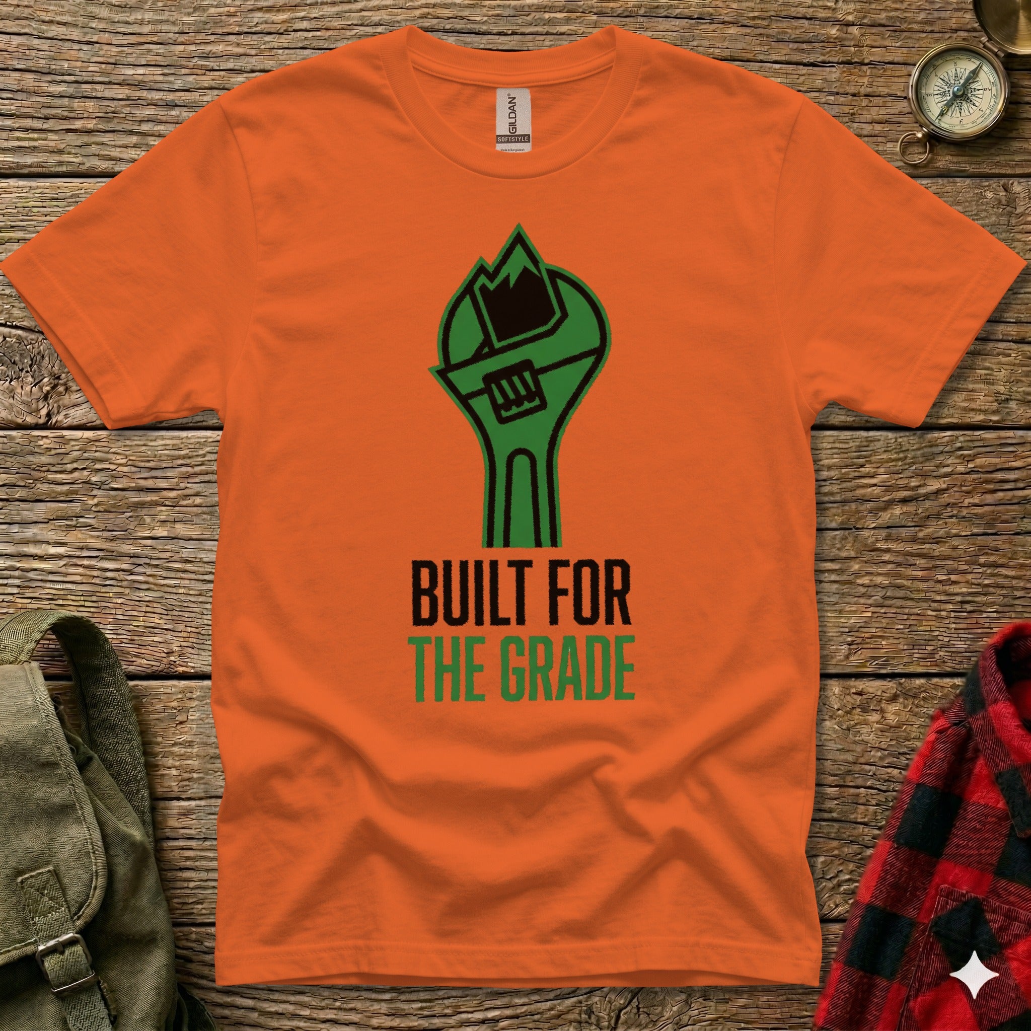 Orange t-shirt with green wrench and "Built for the Grade" text.