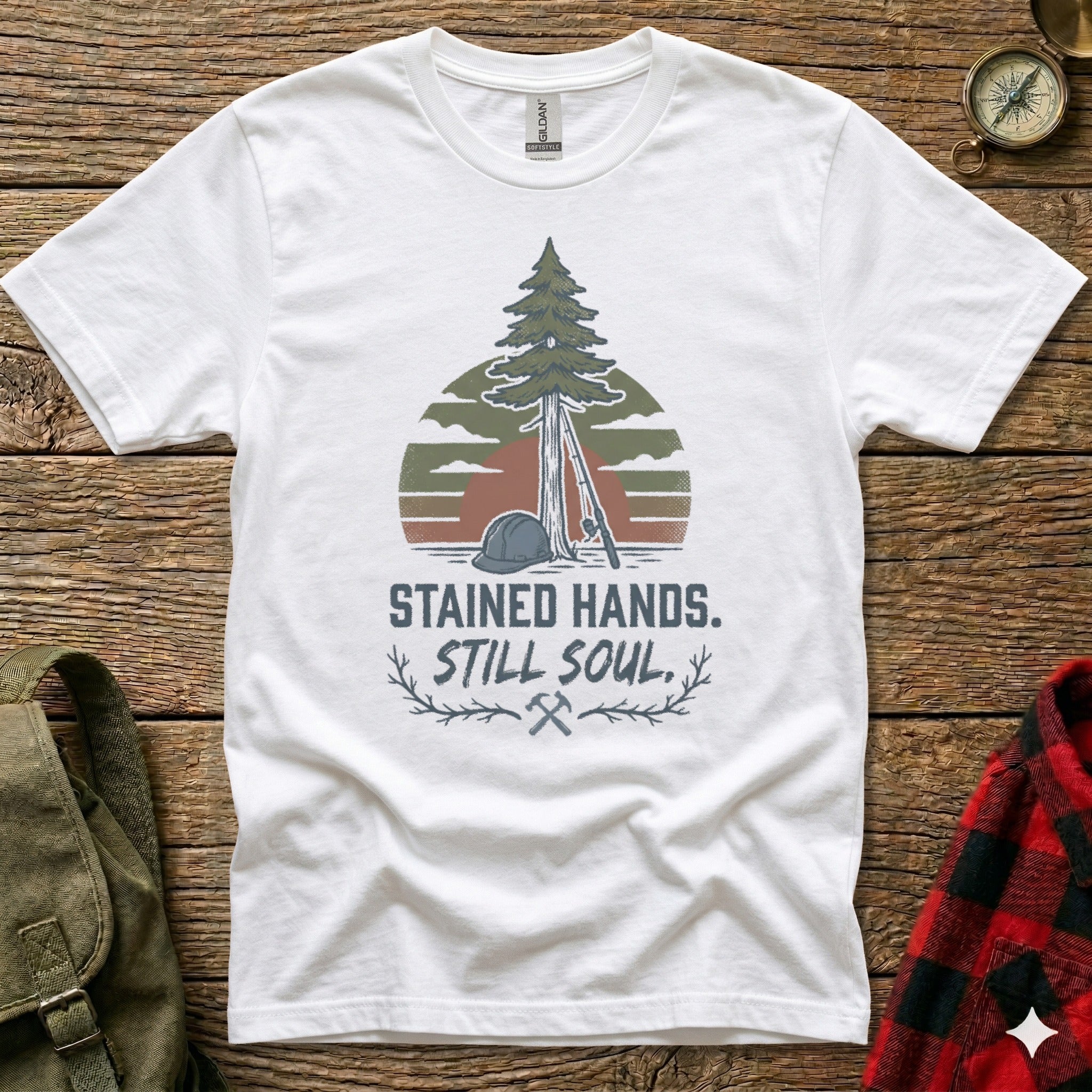 White t-shirt with a pine tree, hard hat, and lumberjack axe graphic.