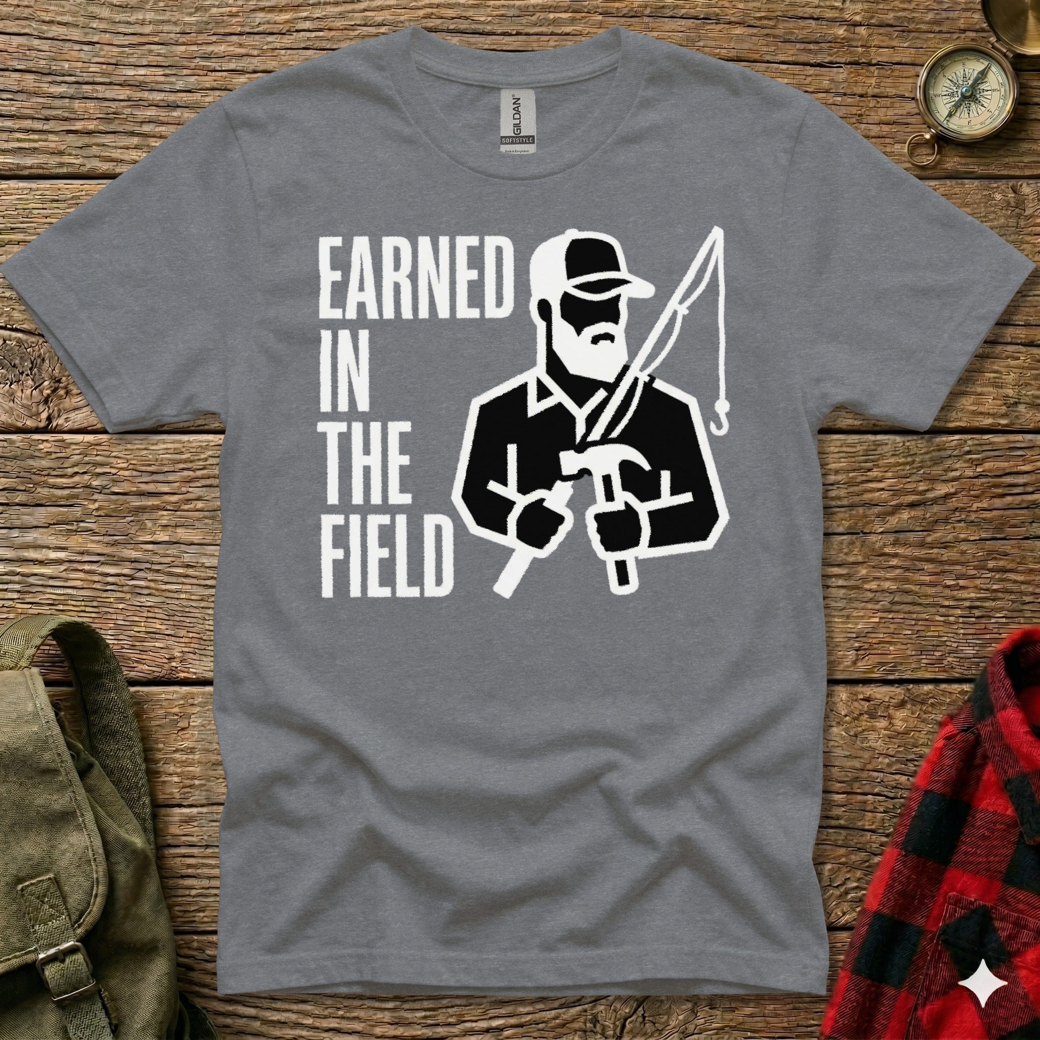 Grey t-shirt with "Earned in the Field" text and a fisherman graphic.