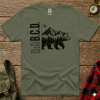 Olive green t-shirt with "B.C.D. LIVING ON THAT BLUE COLLAR DOLLAR" and bear in mountains graphic.