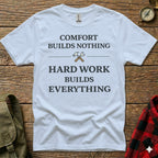 White t-shirt with "COMFORT BUILDS NOTHING HARD WORK BUILDS EVERYTHING" text.