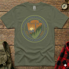Olive green t-shirt with circular "Chief Mountain Guide Household Maintenance" graphic.