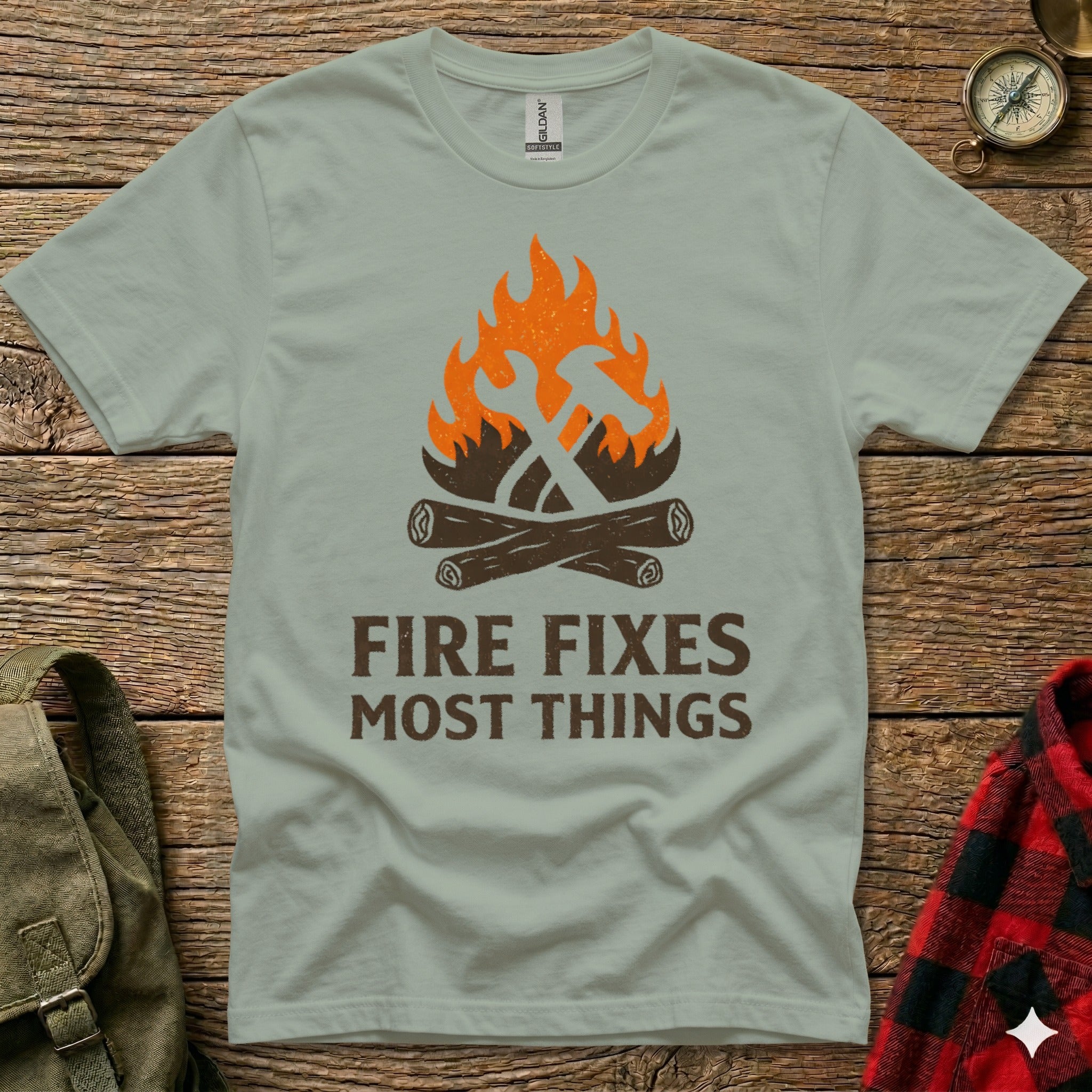 T-shirt with graphic of hammer and wrench crossed over campfire.