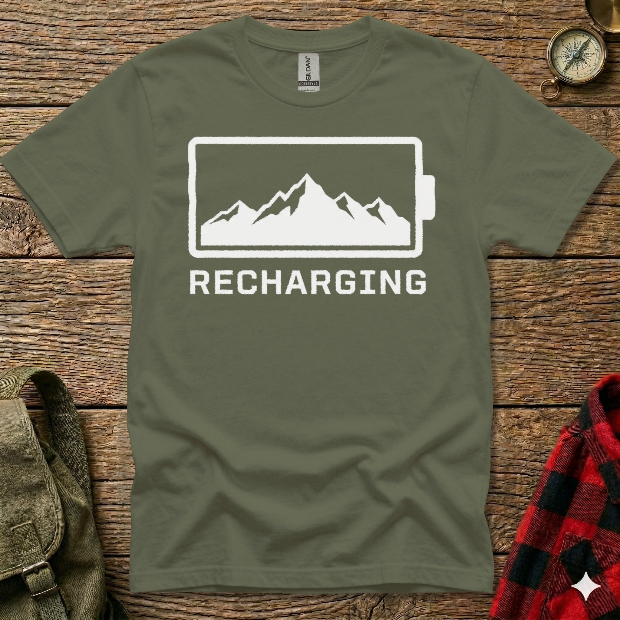 Olive green t-shirt with "RECHARGING" text and a mountain landscape inside a battery icon.