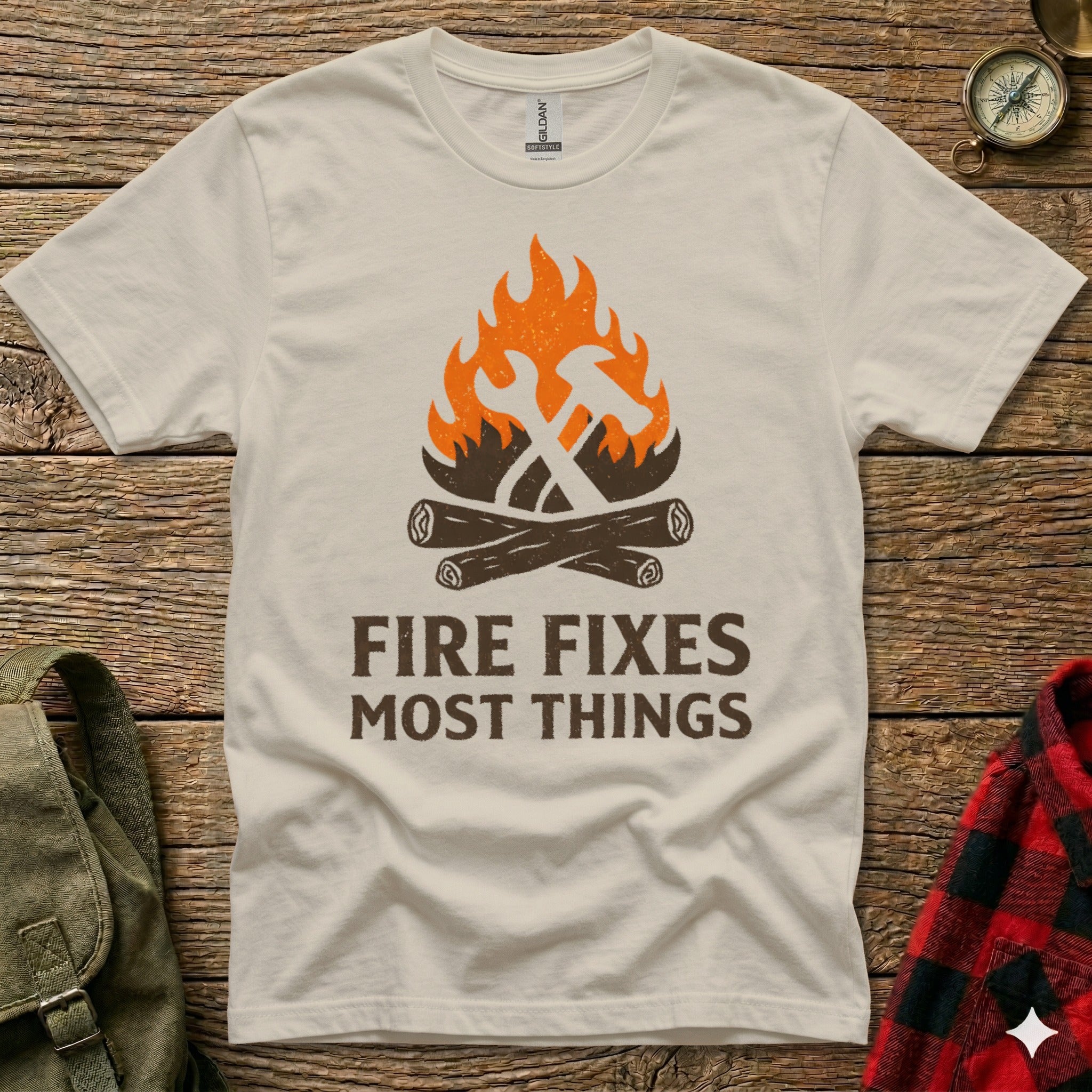 T-shirt with orange flames and crossed hammer and wrench over wood logs.
