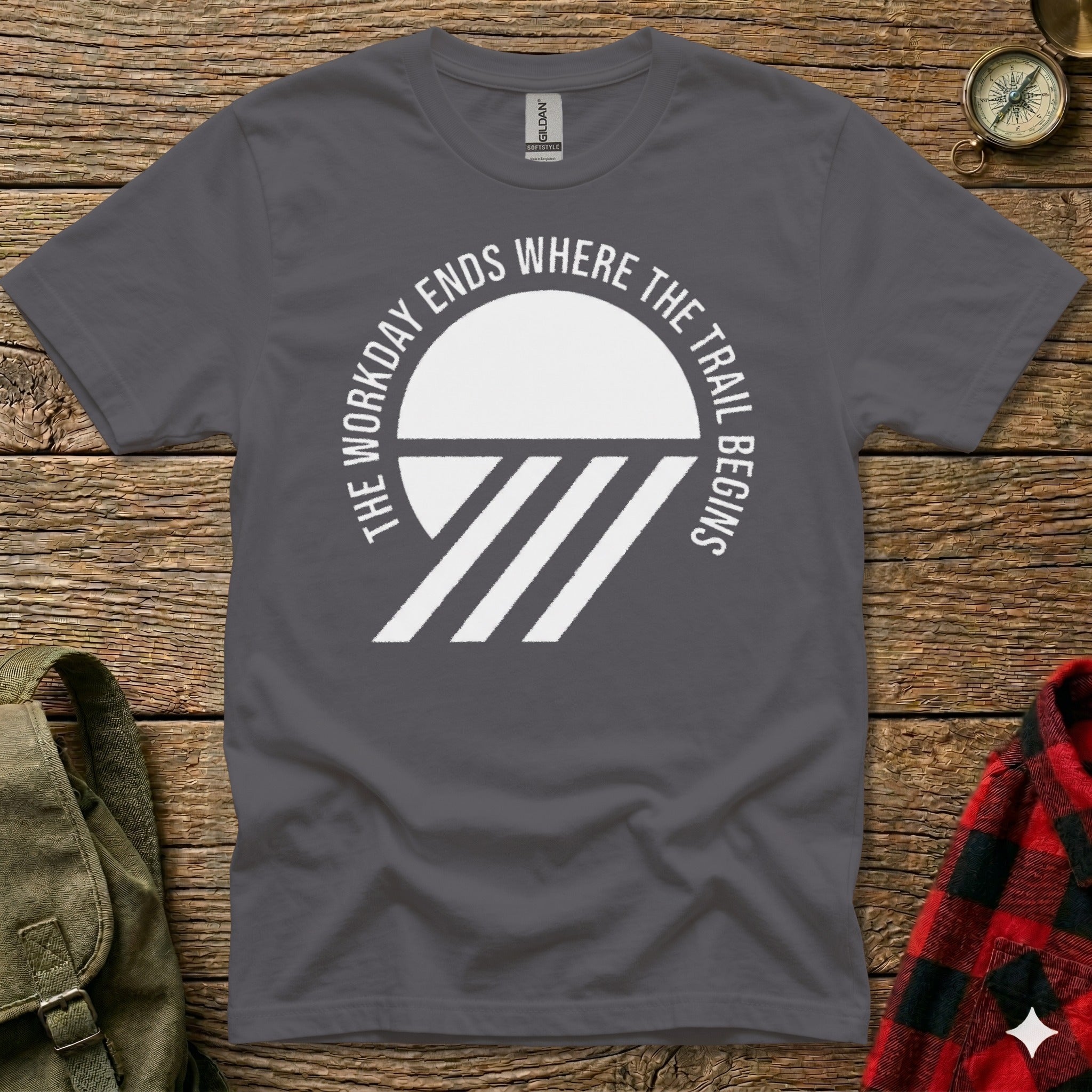 Dark grey t-shirt with white text and graphic: "The workday ends where the trail begins."