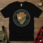 Black t-shirt with circular "Chief Mountain Guide Household Maintenance" logo.