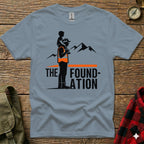 Man carrying child on shoulders in front of mountains, with "THE FOUNDATION" text.