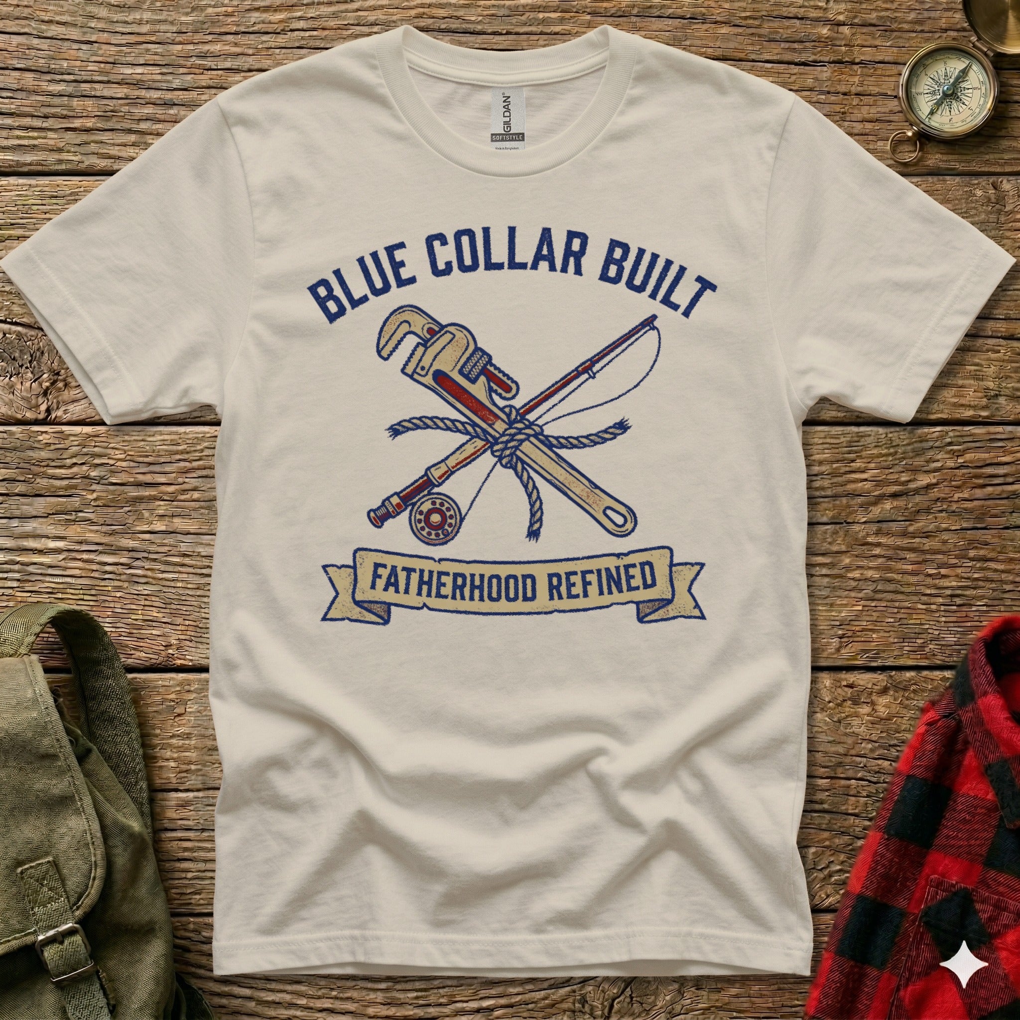 White t-shirt with "Blue Collar Built" and "Fatherhood Refined" text, and crossed wrench and fishing rod graphic.