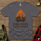 Grey t-shirt with "FIRE FIXES MOST THINGS" text and crossed hammer and axe over flames.