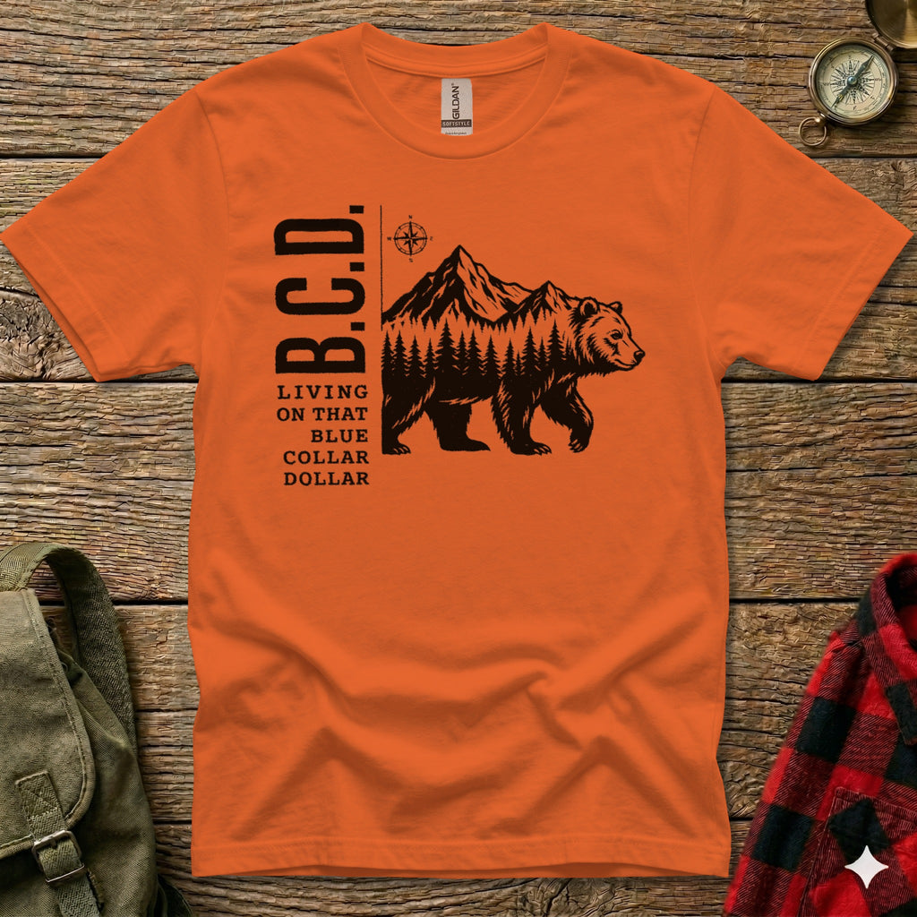 Orange t-shirt with bear and mountain graphic and text "B.C.D. Living on that Blue Collar Dollar".