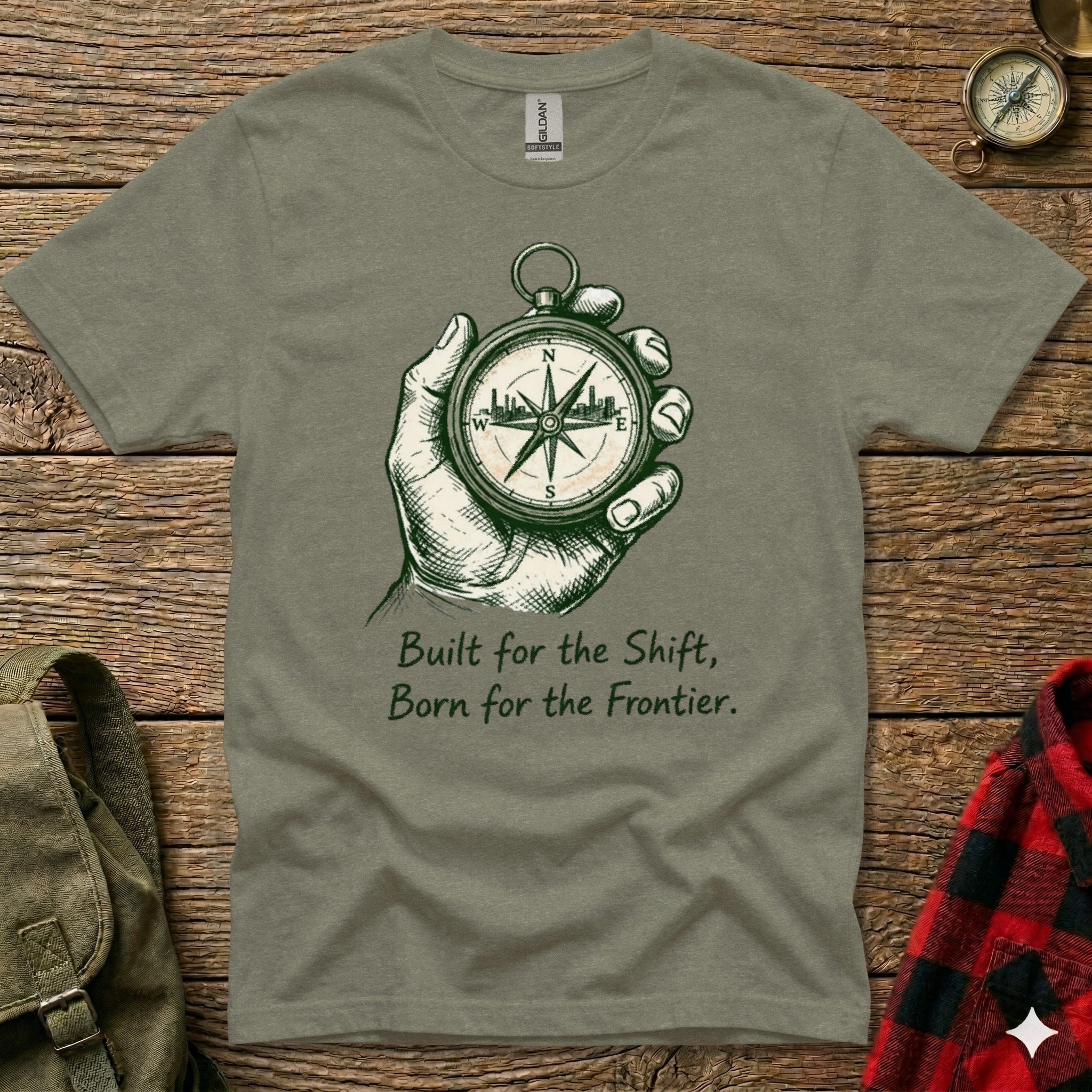 T-shirt with hand holding compass and text "Built for the Shift, Born for the Frontier."