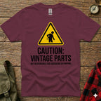 Maroon t-shirt with yellow caution sign, "Vintage Parts," and "Not Responsible for Squeaking or Popping."