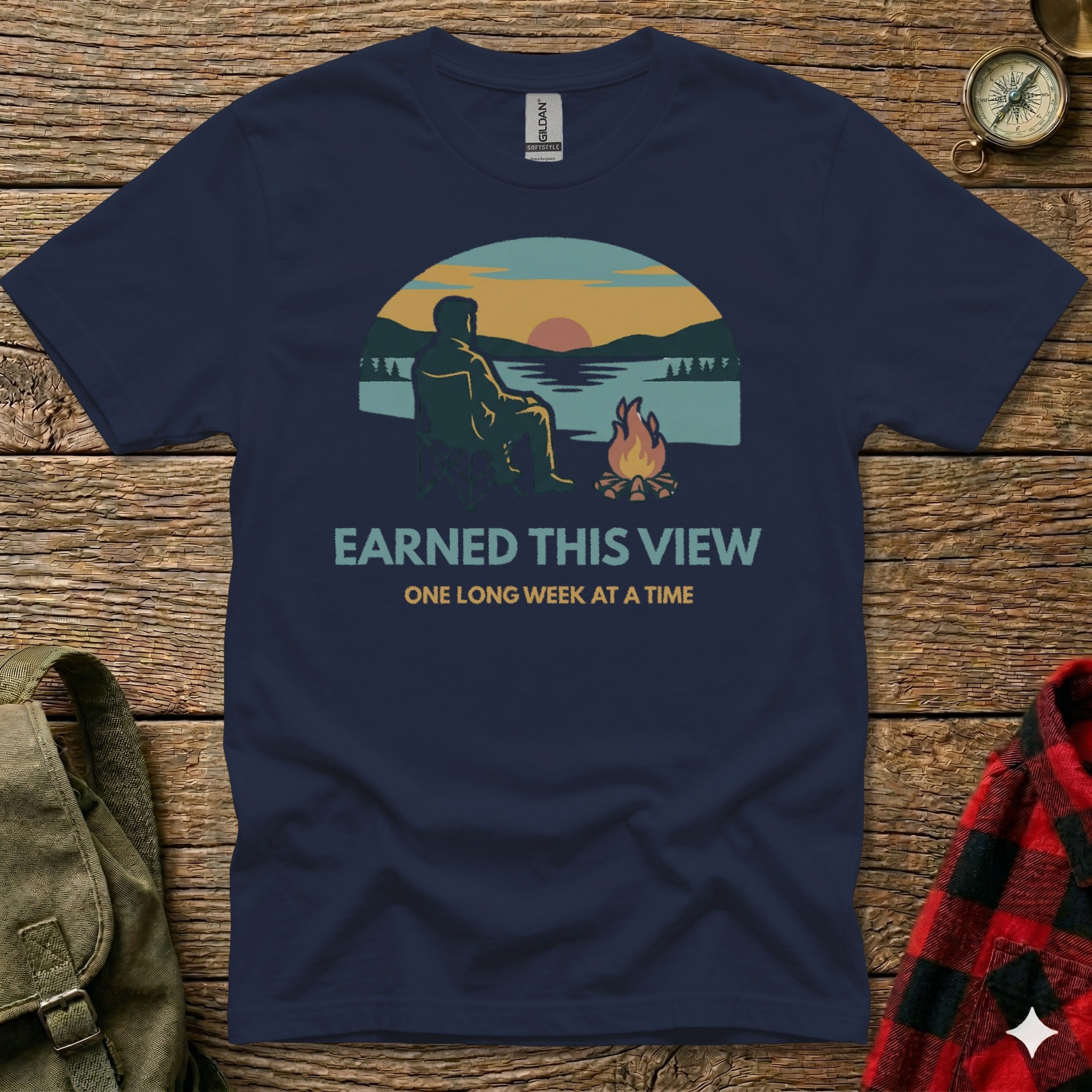 Dark blue t-shirt with campfire, sunset, and text "Earned This View One Long Week at a Time".