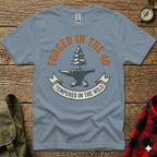 Grey t-shirt with "Forged in the 40, Tempered in the Wild" text and anvil/tree graphic.