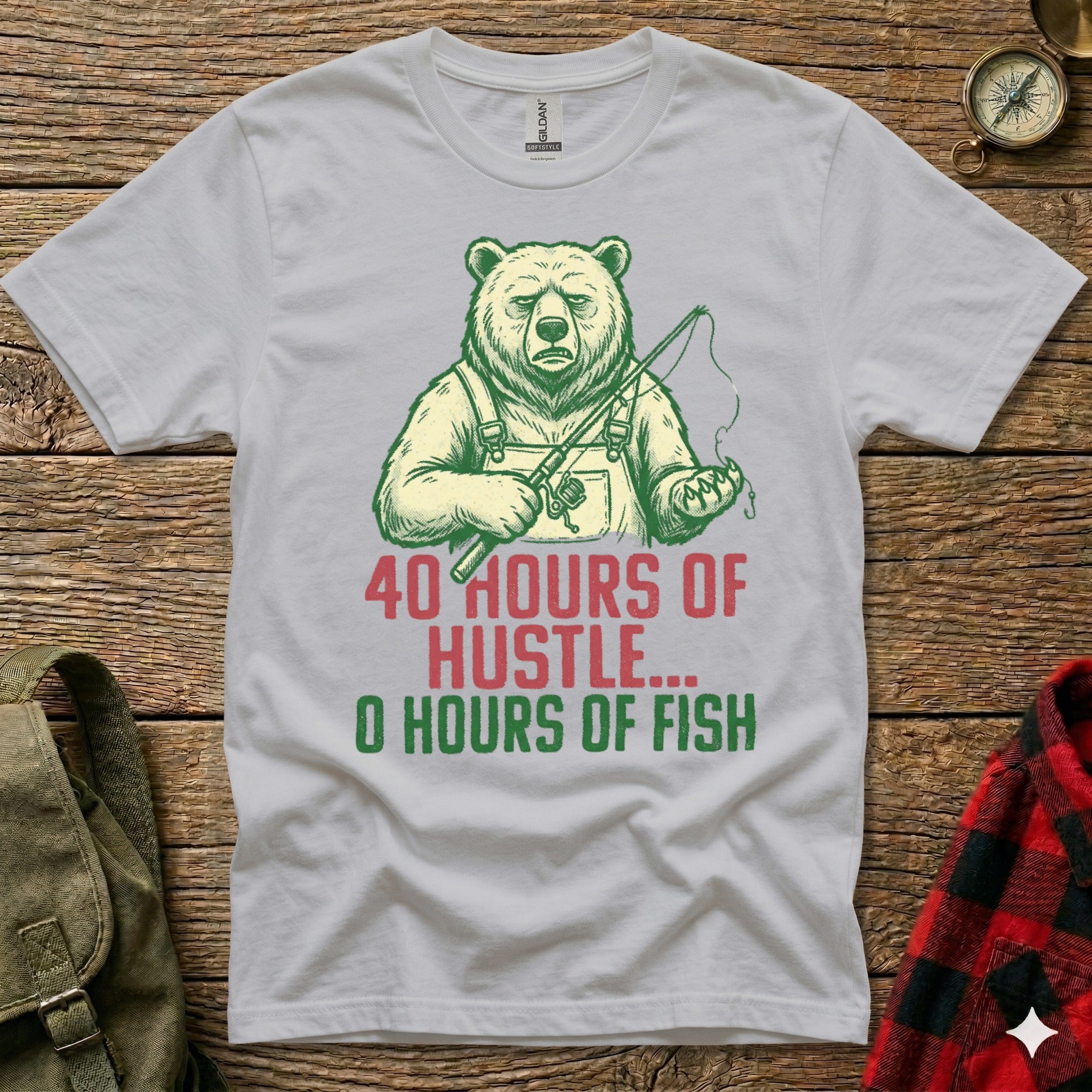 White t-shirt with graphic of a bear fishing and text: "40 Hours of Hustle... 0 Hours of Fish"