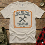 White t-shirt with "High Mileage Low Maintenance Blue Collar & Broken In Est. 1950" graphic.