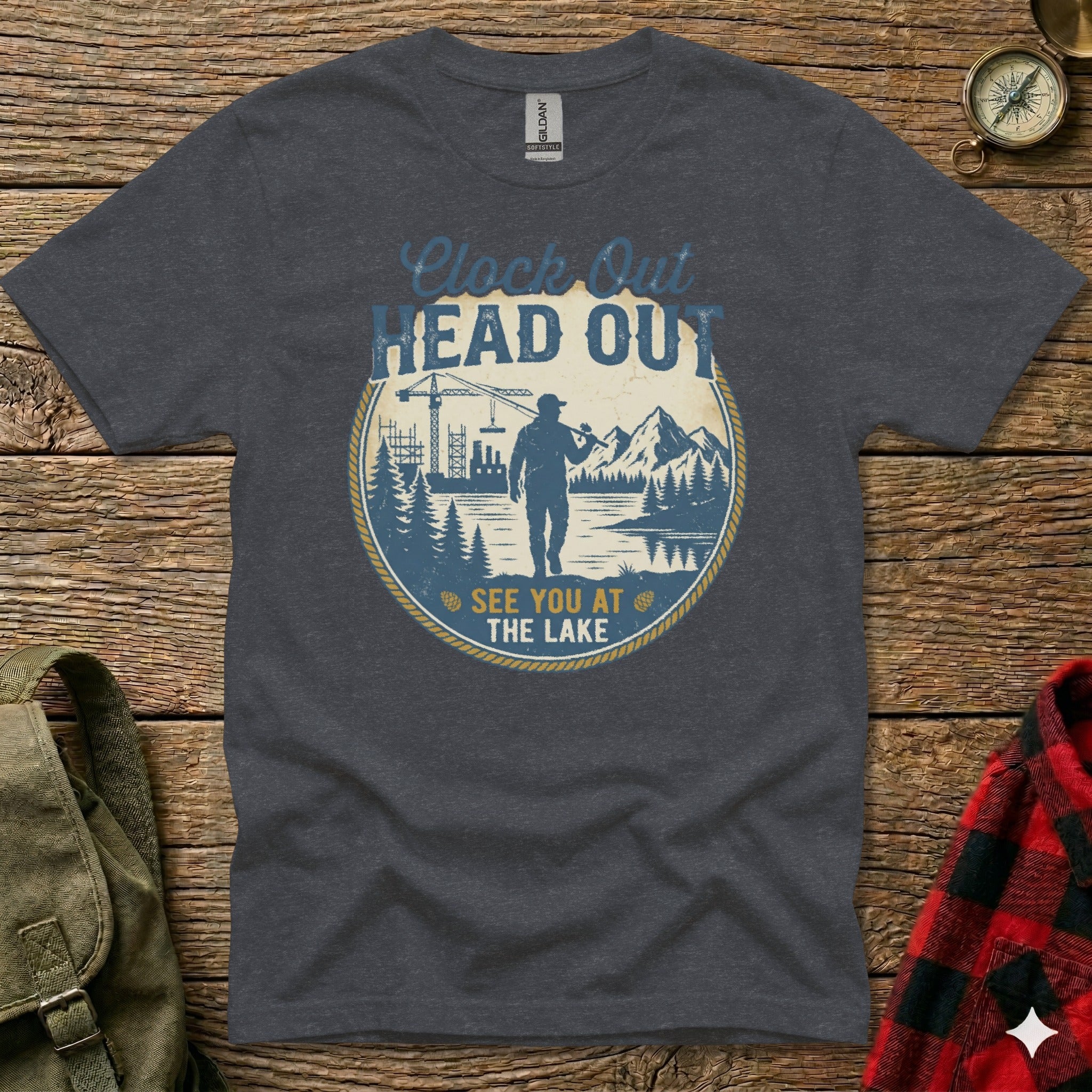 Dark gray t-shirt with "Clock Out Head Out See You At The Lake" text and fishing graphic.