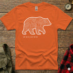 Orange t-shirt with white bear silhouette filled with topographic lines and coordinates.