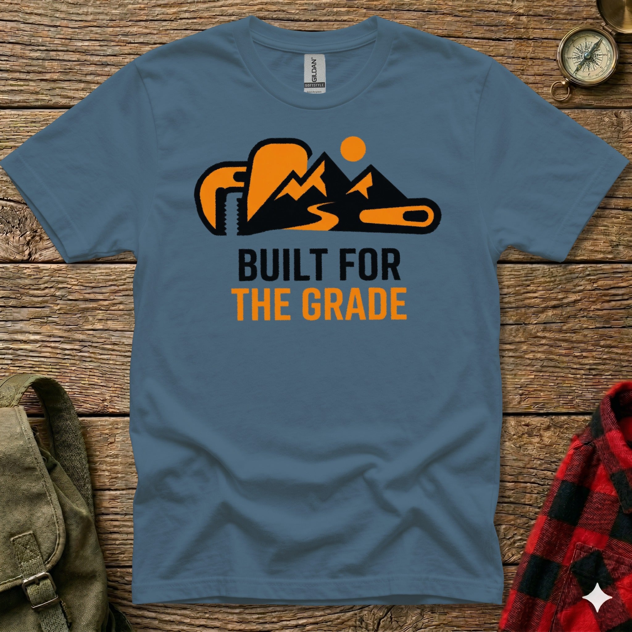 Blue t-shirt with orange mountain and wrench graphic, "BUILT FOR THE GRADE" text.