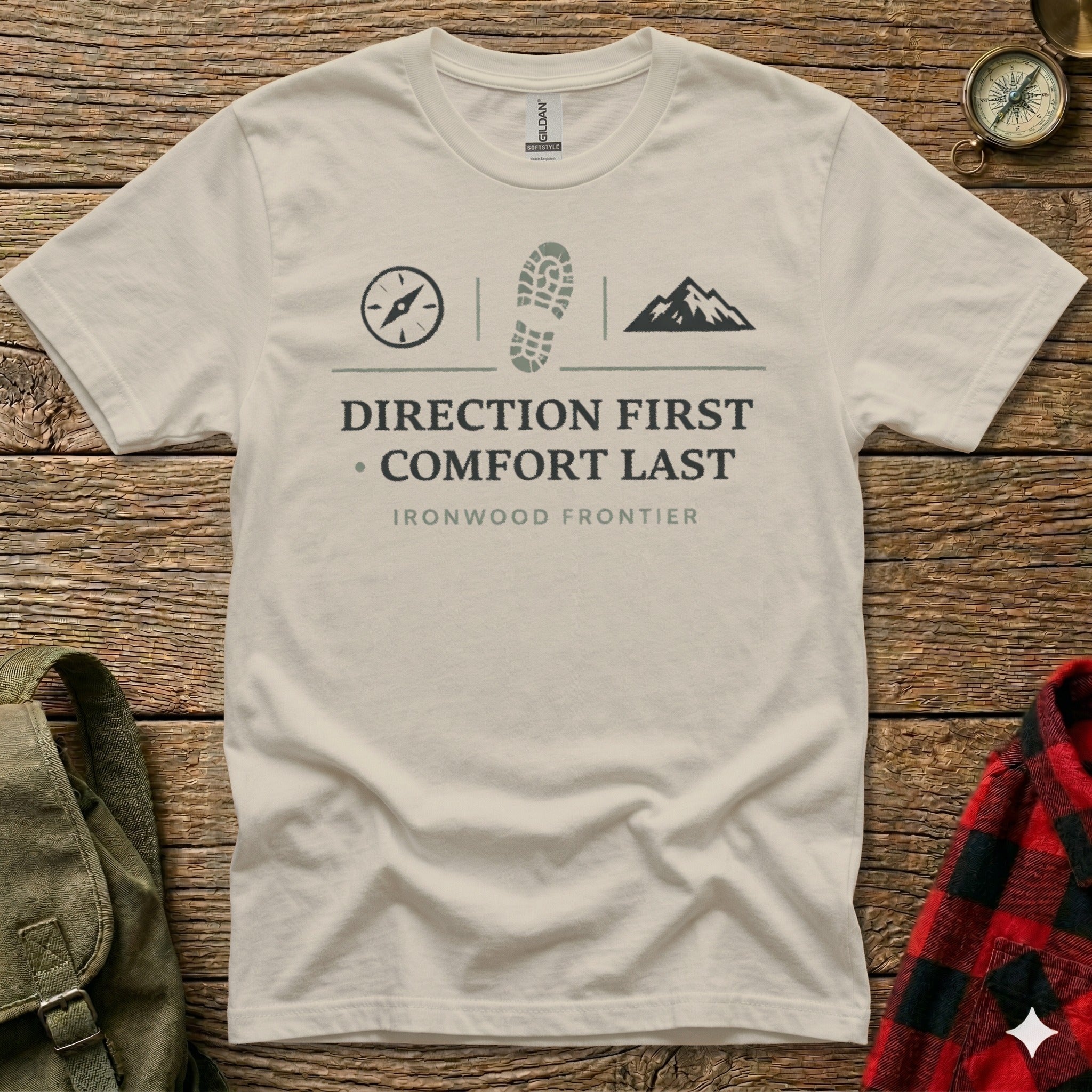 T-shirt with "DIRECTION FIRST COMFORT LAST" and mountain and boot print graphics.