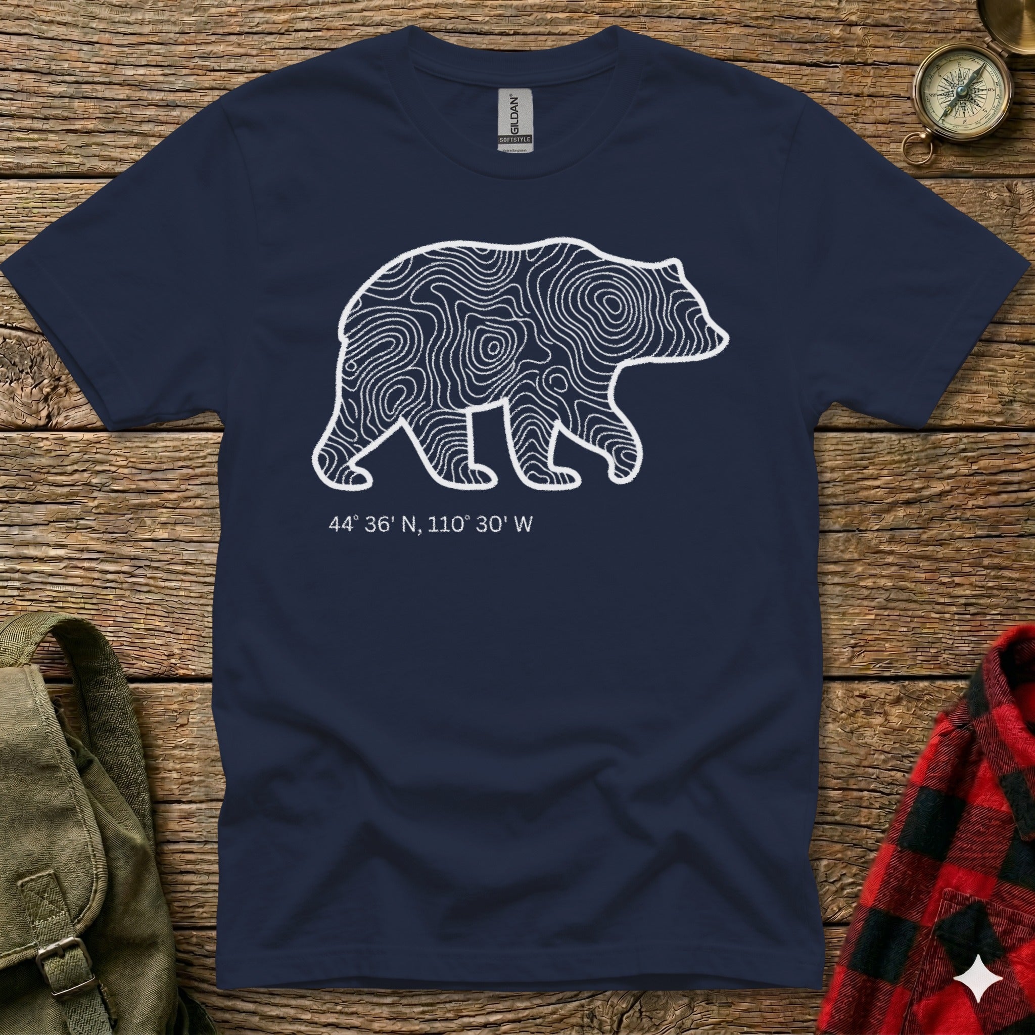 Navy t-shirt with white bear outline filled with topographic map lines and coordinates.
