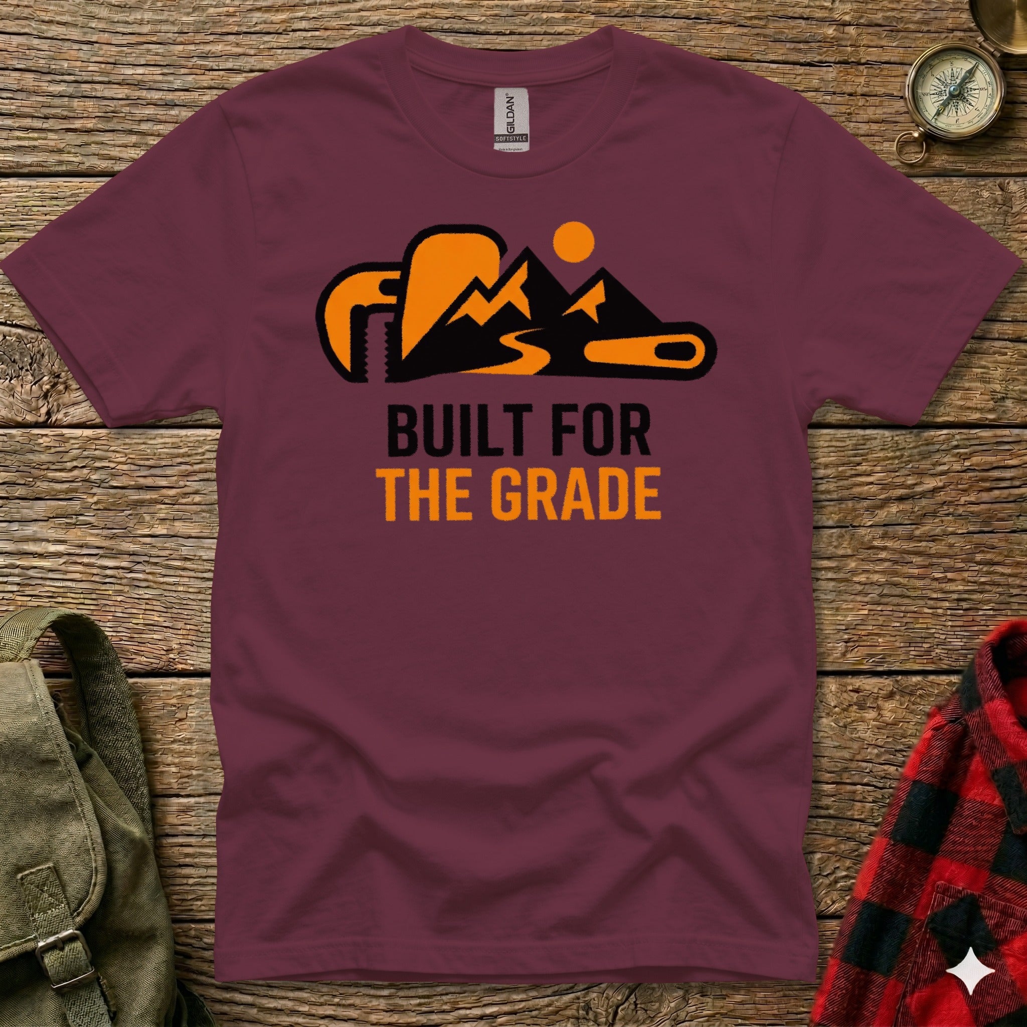 Maroon t-shirt with orange mountain graphic and "BUILT FOR THE GRADE" text.