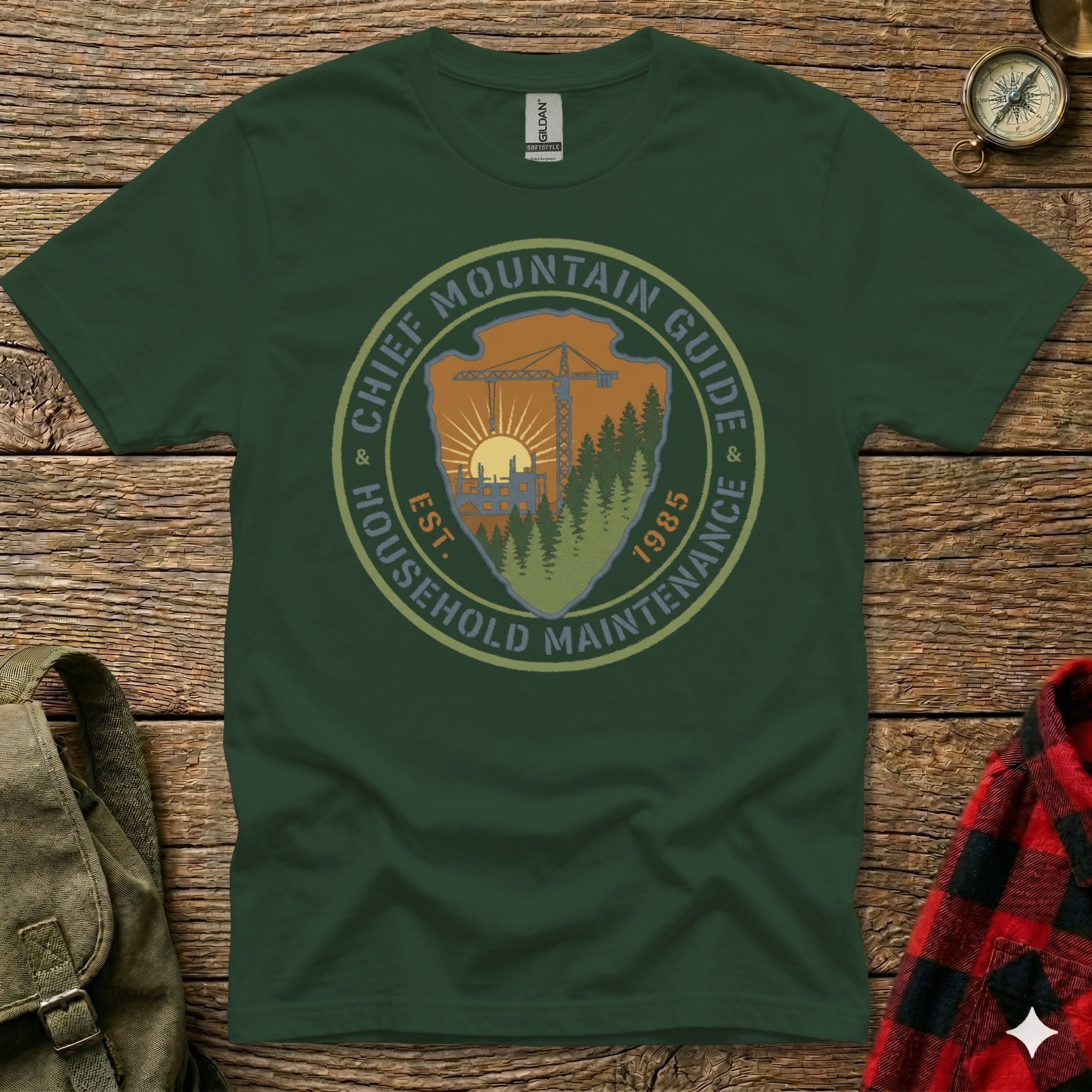 Green t-shirt with "Chief Mountain Guide Household Maintenance" logo.