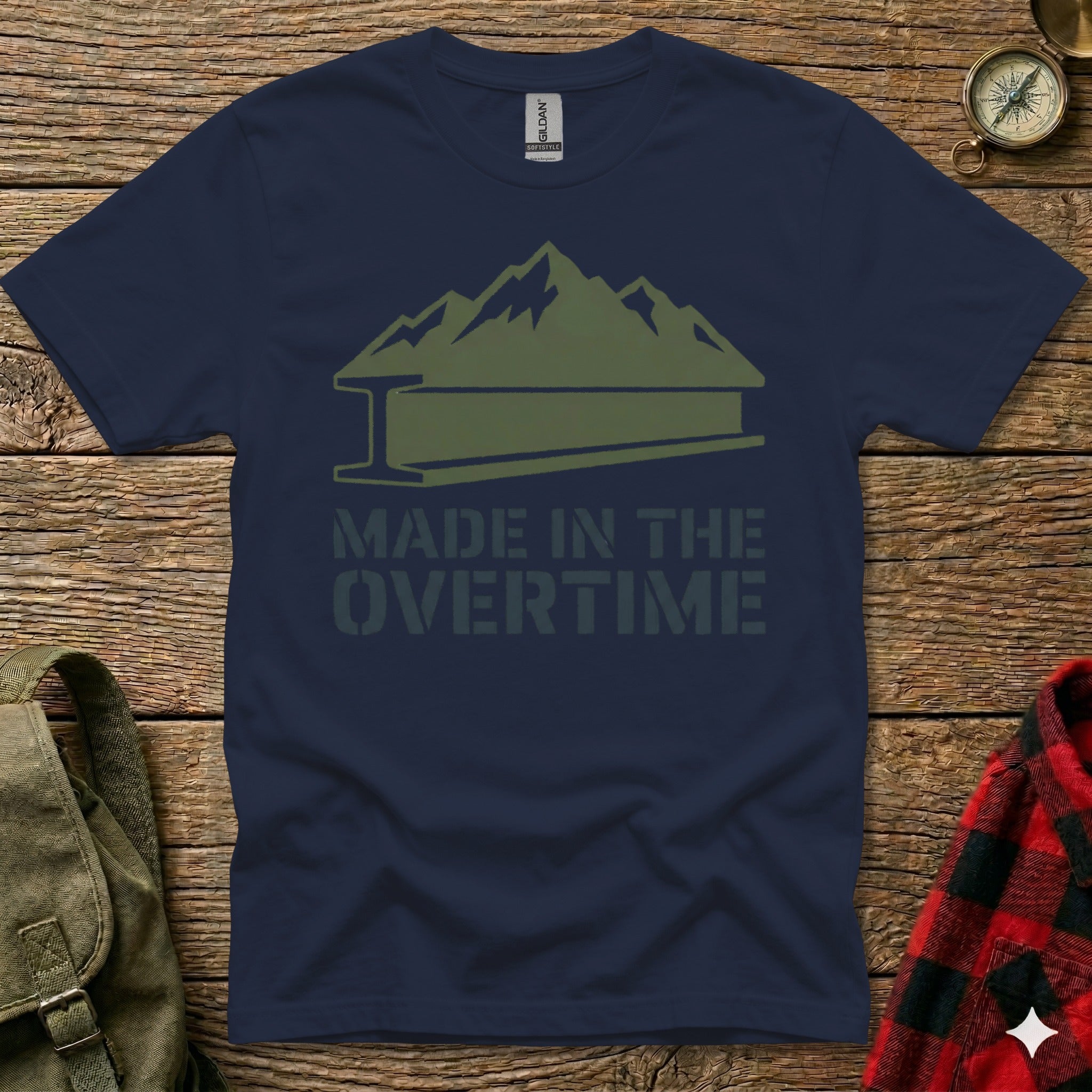 Navy t-shirt with "Made in the Overtime" mountain logo and plaid shirt detail.