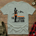 Gray t-shirt with "THE FOUNDATION" text and mountain graphic.