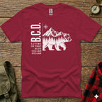 Burgundy t-shirt with white bear, mountain, and text "B.C.D. LIVING ON THAT BLUE DOLLAR".