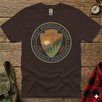 Brown t-shirt with "Chief Mountain Guide Household Maintenance" circular logo.