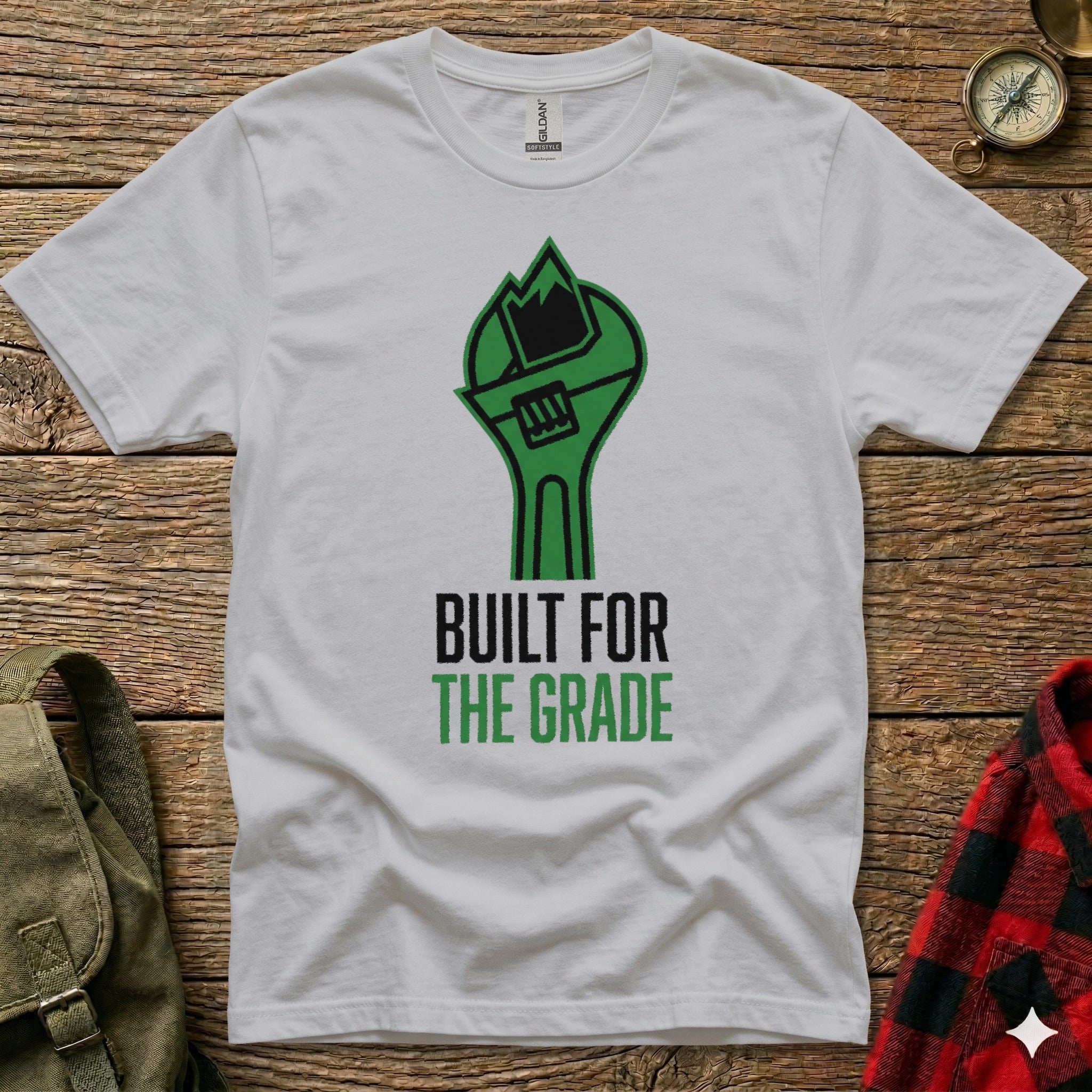 White t-shirt with green wrench graphic and text "BUILT FOR THE GRADE".