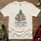 White t-shirt with forest and text "STAINED HANDS. STILL SOUL."