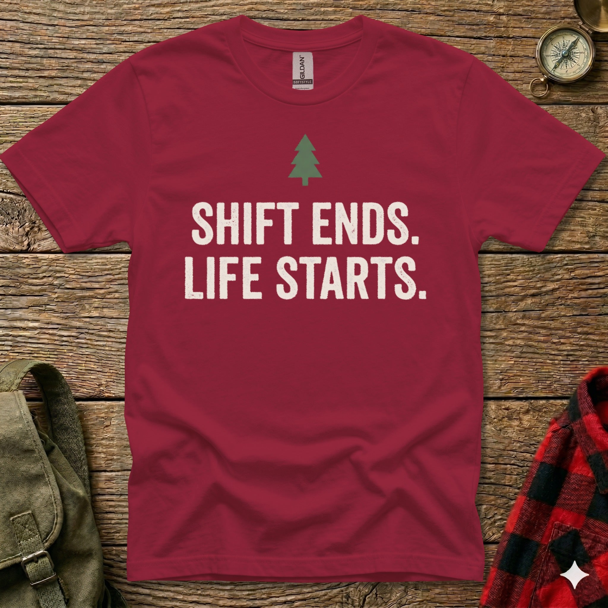 Burgundy t-shirt with white text "SHIFT ENDS. LIFE STARTS." and a small green tree.