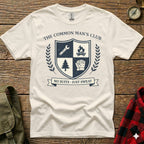 Cream t-shirt with "The Common Man's Club" crest featuring shield, tree, and gloves.