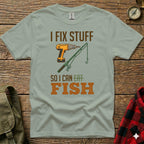 Green t-shirt with "I FIX STUFF SO I CAN EAT FISH" text and drill and fishing rod graphic.