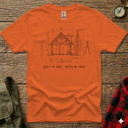 Orange t-shirt with diagram of a cabin and text "BUILT TO SPEC, TESTED BY TRAIL".