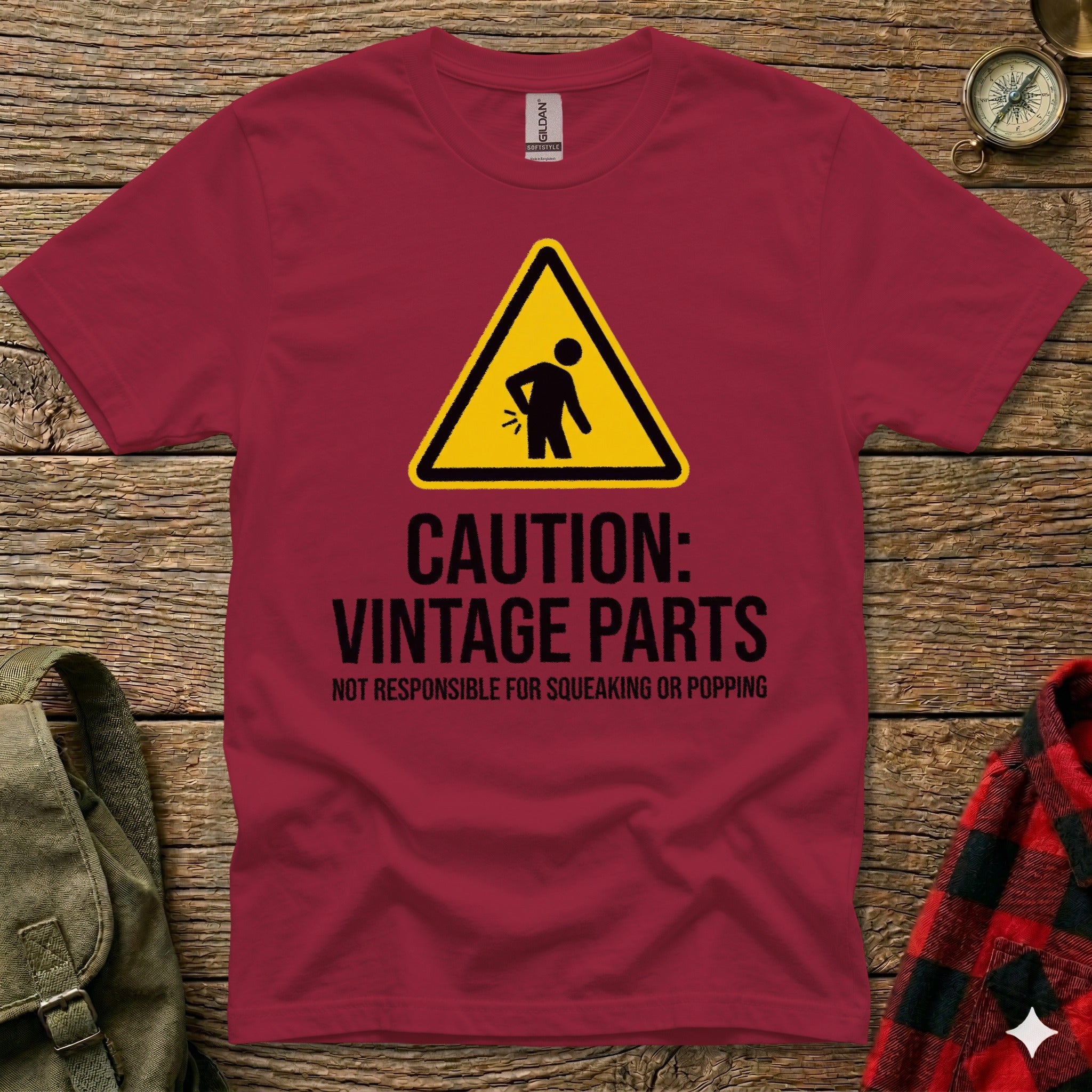 Maroon t-shirt with "CAUTION: VINTAGE PARTS" warning graphic.