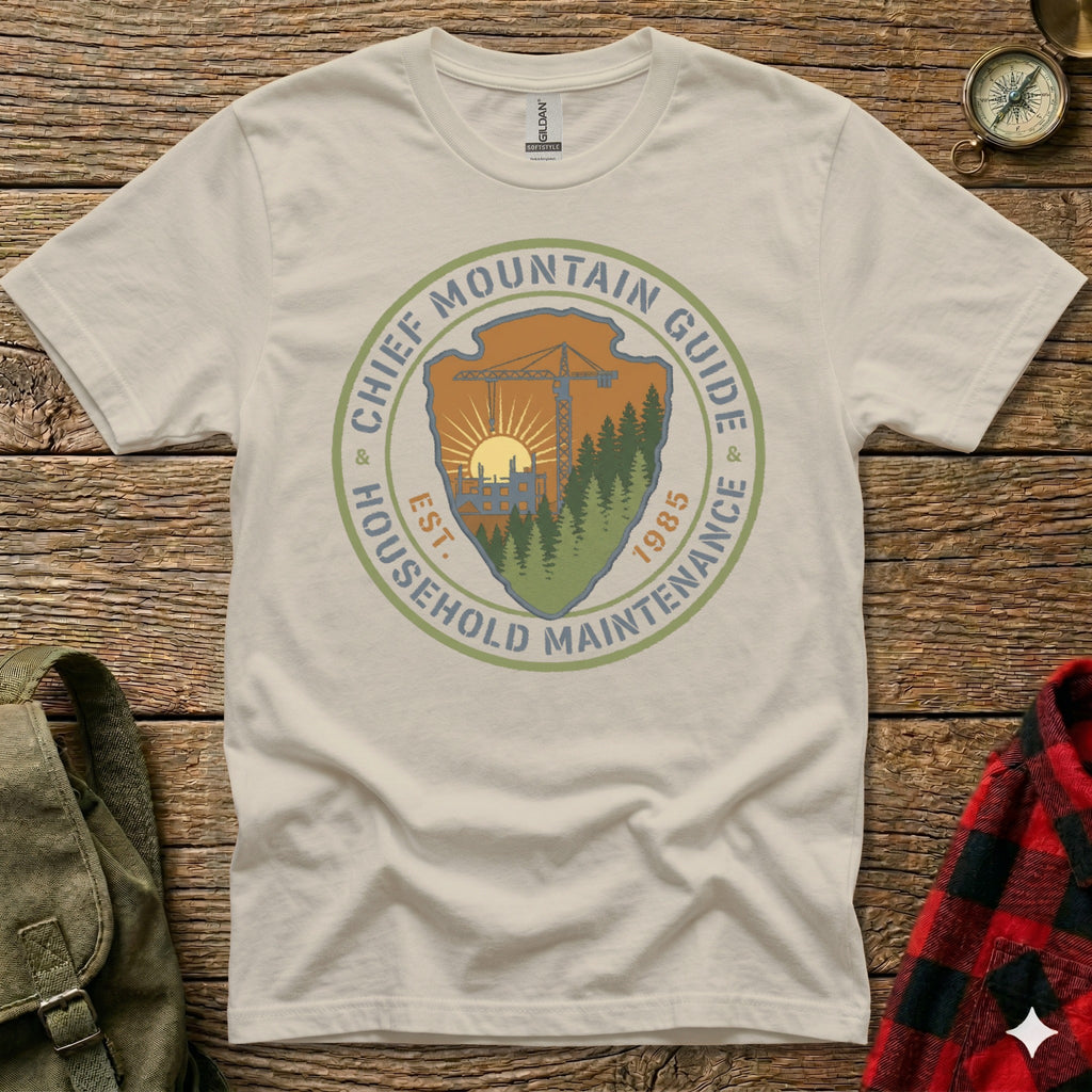 Cream t-shirt with "Chief Mountain Guide Household Maintenance Est. 1985" circular logo.
