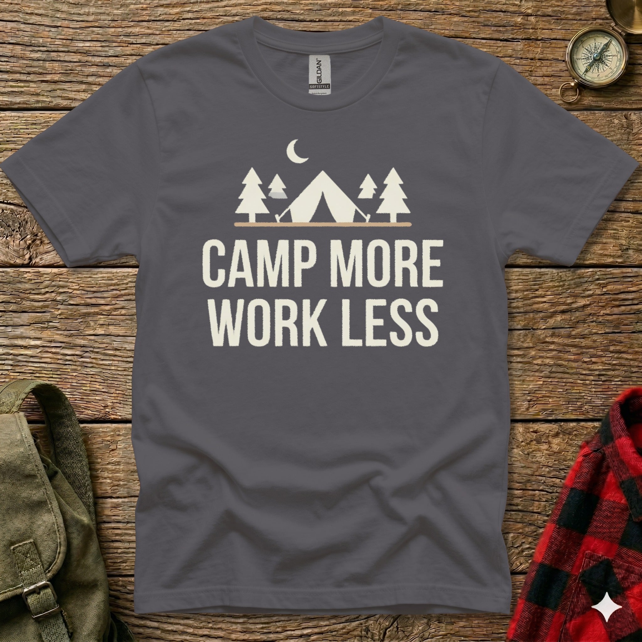 Dark grey t-shirt with white camping tent and tree graphic, "CAMP MORE WORK LESS" text.